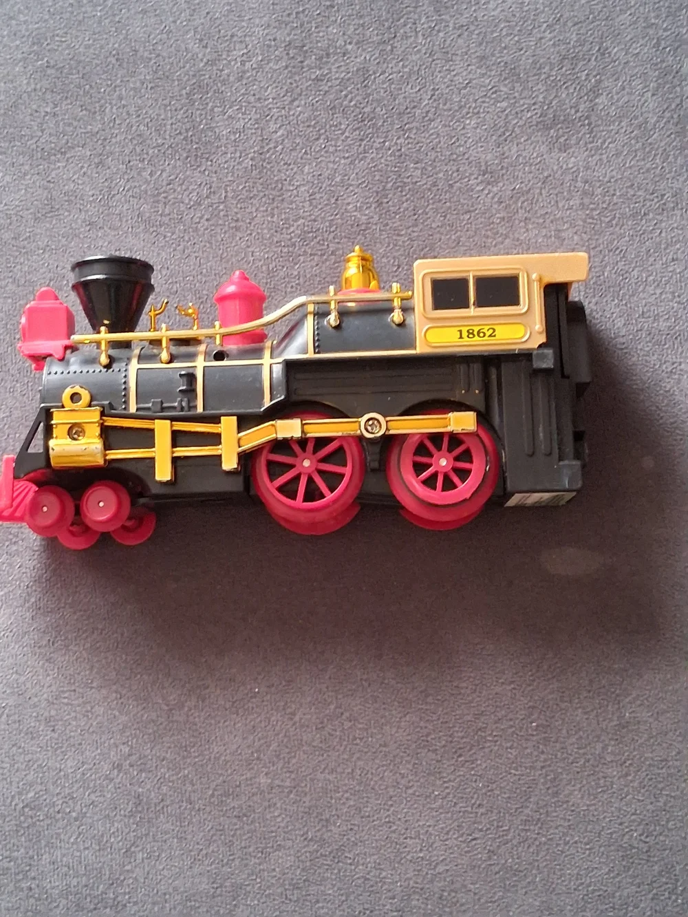 Vintage Style Black and Gold Toy Train with Red Accents